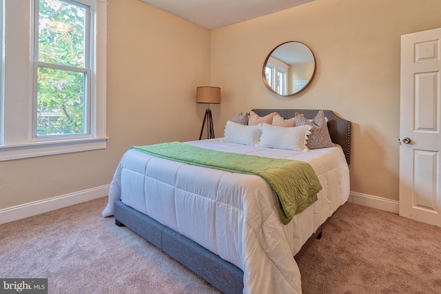 bedroom with carpet floors and baseboards