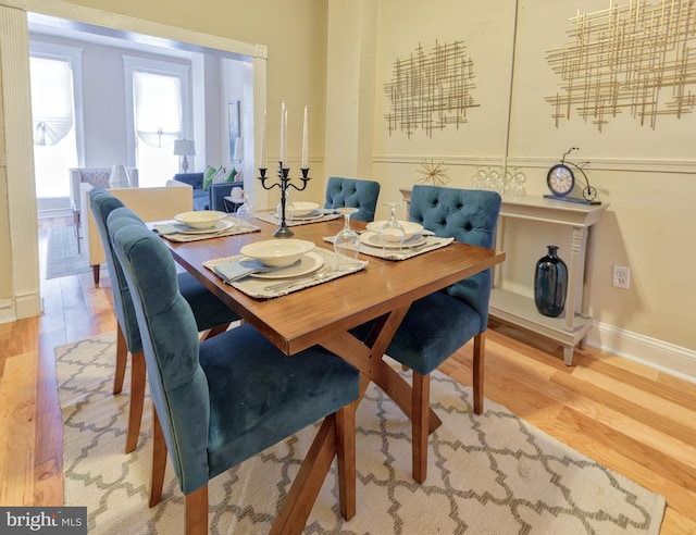 dining room featuring baseboards and wood finished floors