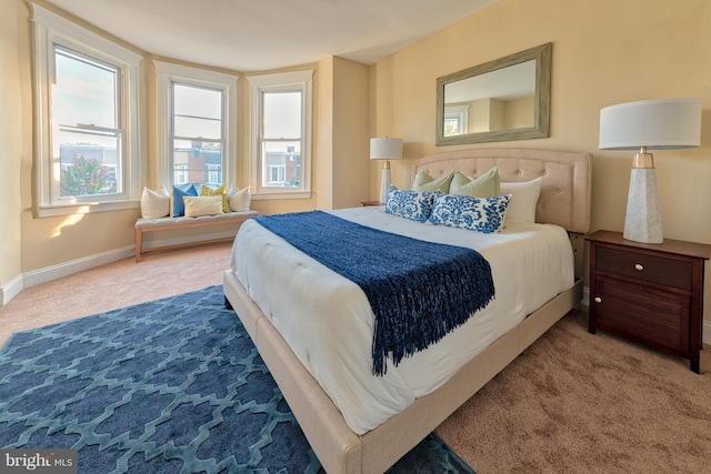 carpeted bedroom featuring baseboards