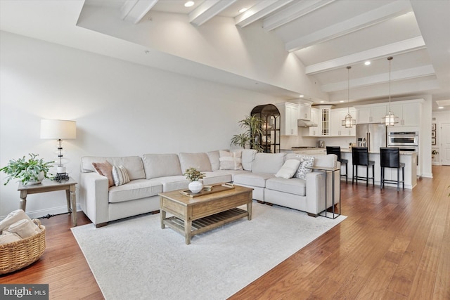 living area featuring dark wood-style floors, recessed lighting, beam ceiling, and high vaulted ceiling