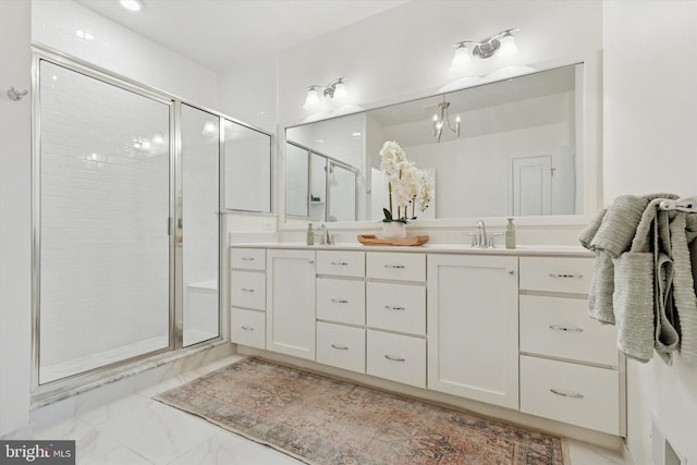 bathroom with double vanity, visible vents, marble finish floor, a shower stall, and a sink