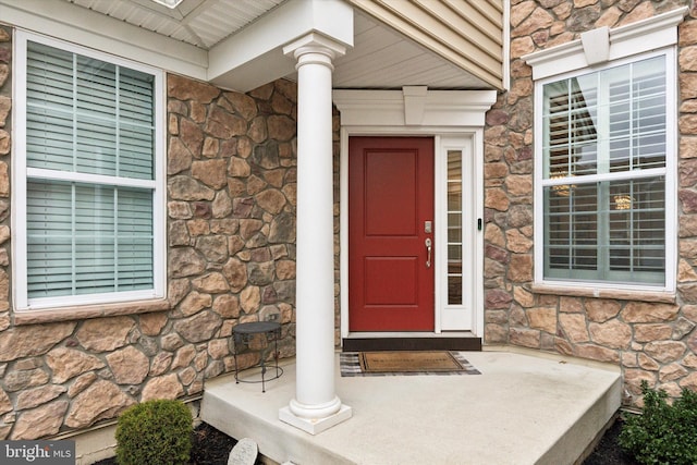 property entrance featuring stone siding