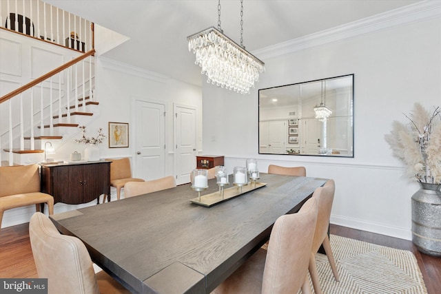 dining room featuring stairs, ornamental molding, and wood finished floors