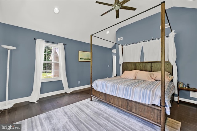 bedroom featuring lofted ceiling, wood finished floors, visible vents, and baseboards