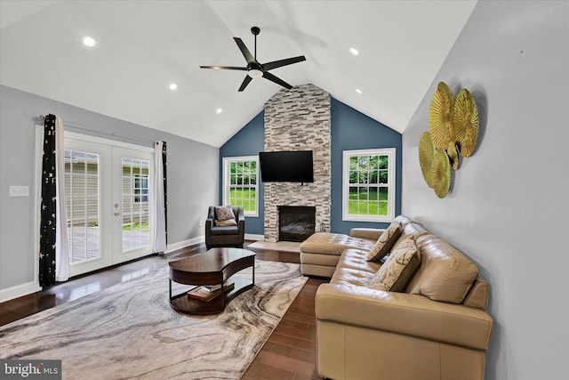 living room featuring dark wood-style flooring, baseboards, a fireplace, and french doors