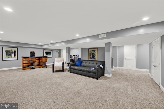 carpeted living area featuring baseboards, visible vents, and recessed lighting