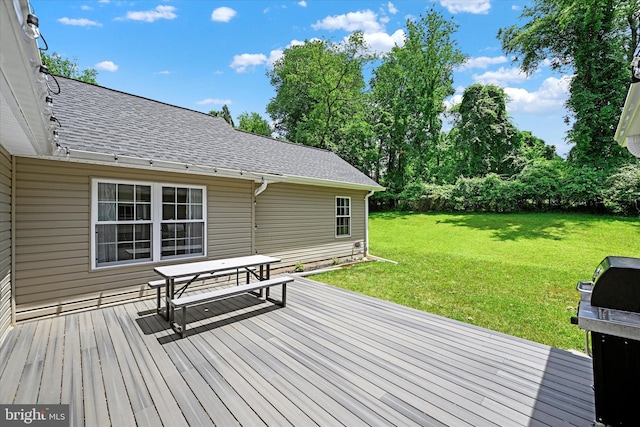 wooden terrace featuring a yard and area for grilling