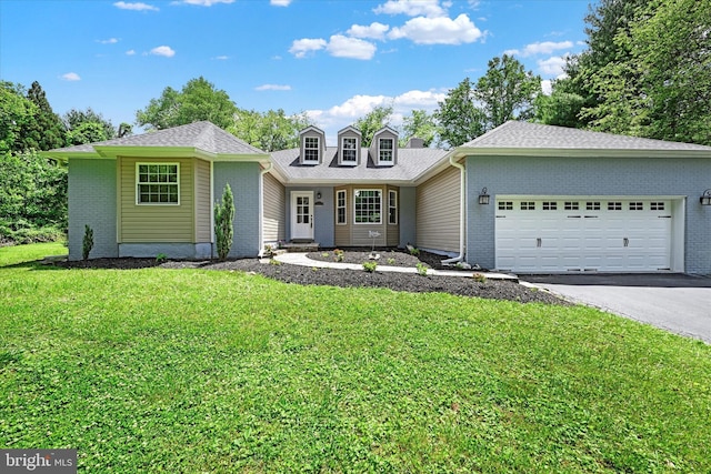 view of front facade with aphalt driveway, a front yard, brick siding, and an attached garage