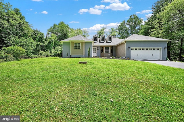 view of front of house featuring driveway, brick siding, an attached garage, and a front yard