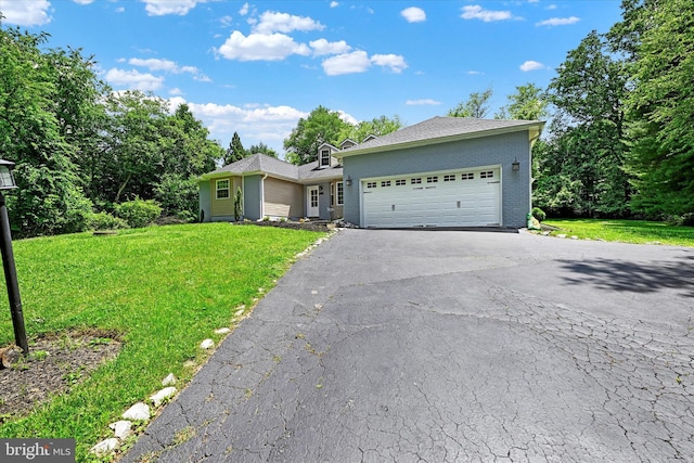 view of front of home featuring a garage, brick siding, driveway, and a front lawn