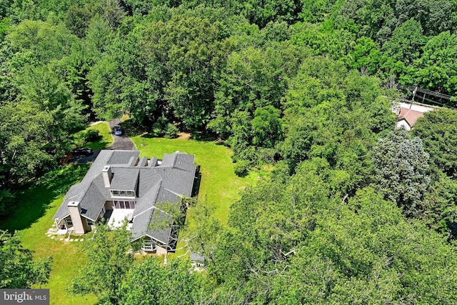 birds eye view of property with a view of trees