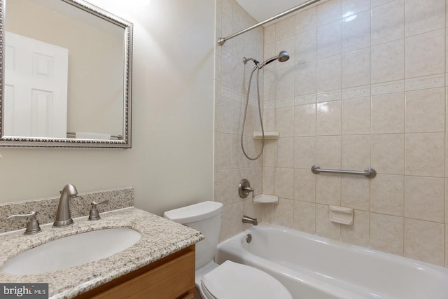 bathroom featuring toilet, bathtub / shower combination, and vanity