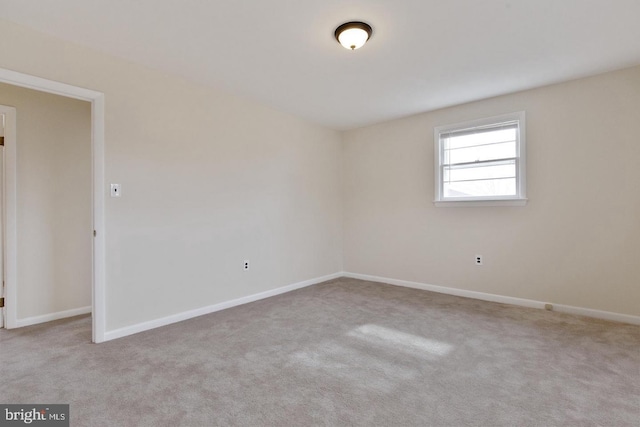 spare room with carpet flooring and baseboards