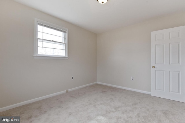 unfurnished room with carpet floors and baseboards