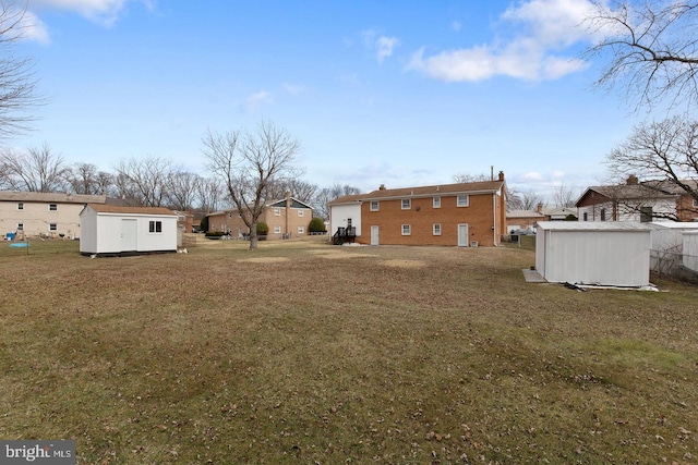 view of yard with a storage unit and an outbuilding