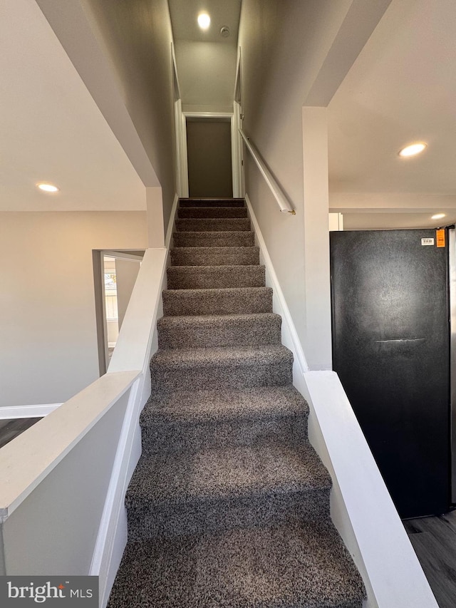 stairway featuring recessed lighting