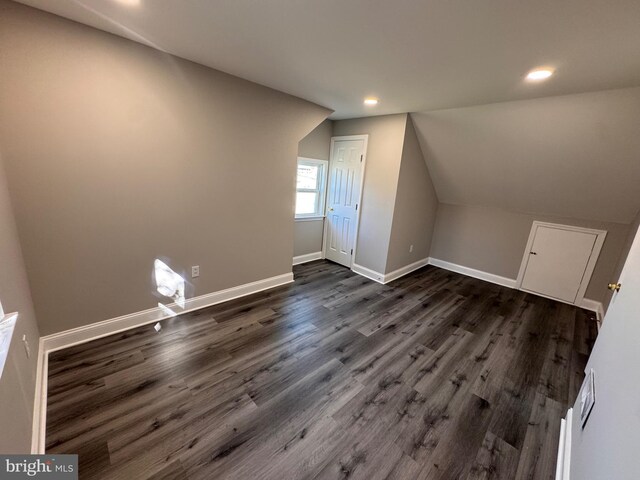 bonus room featuring baseboards, vaulted ceiling, dark wood finished floors, and recessed lighting