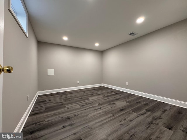 unfurnished room featuring dark wood-style floors, recessed lighting, visible vents, and baseboards