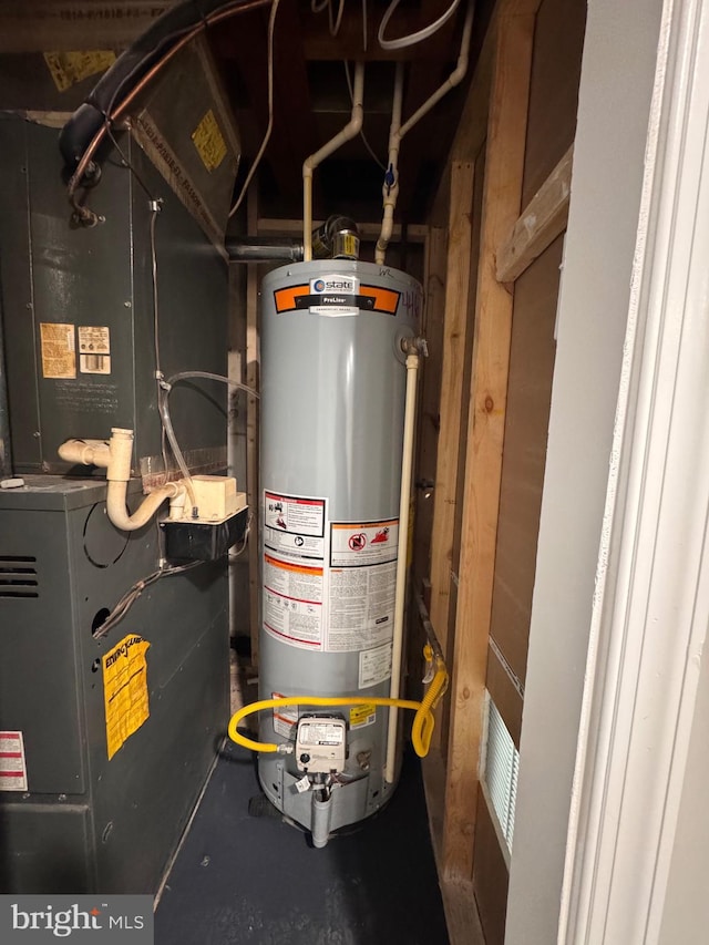 utility room featuring water heater and heating unit