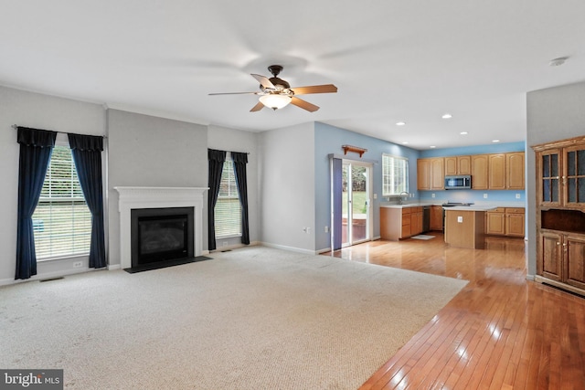 kitchen with a ceiling fan, visible vents, a sink, stainless steel appliances, and light countertops