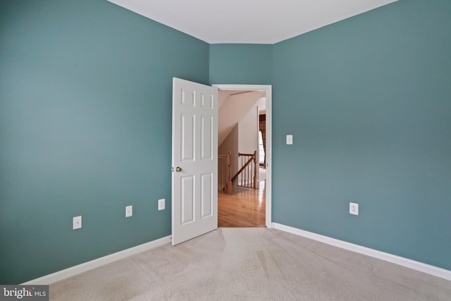 empty room with carpet flooring and baseboards