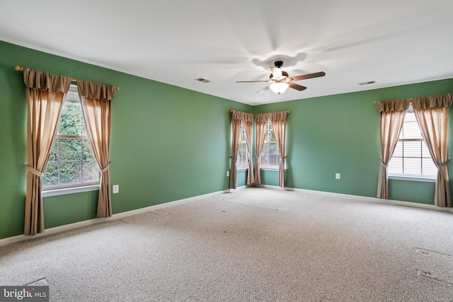 spare room with visible vents, baseboards, carpet, and ceiling fan