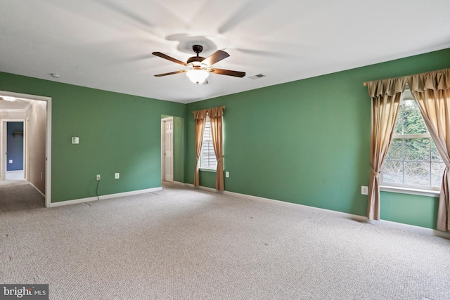 unfurnished room featuring visible vents, carpet flooring, baseboards, and ceiling fan