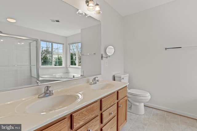 bathroom with a garden tub, toilet, double vanity, and a sink