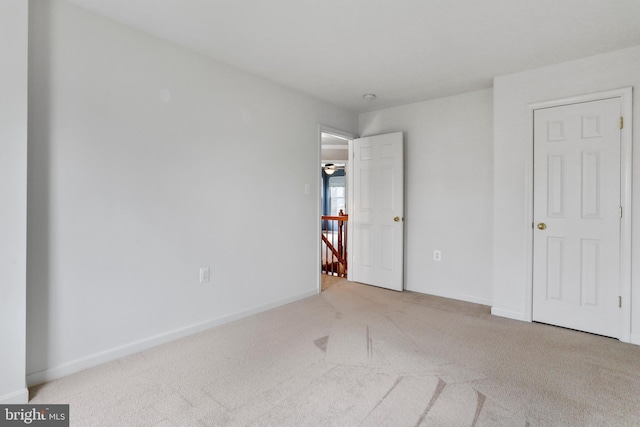 unfurnished bedroom with baseboards and carpet floors