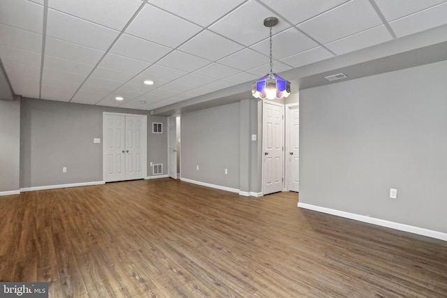 unfurnished living room with visible vents, baseboards, and wood finished floors