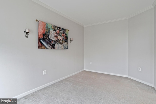 carpeted empty room featuring baseboards and ornamental molding