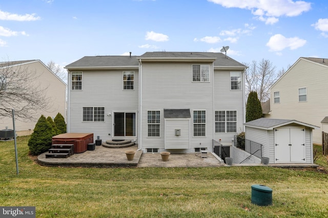 rear view of property with an outdoor structure, a storage unit, a patio area, and a yard