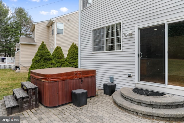 view of patio with a deck and a hot tub