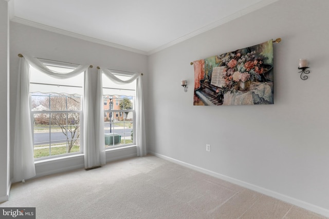 unfurnished room with crown molding, carpet flooring, and baseboards