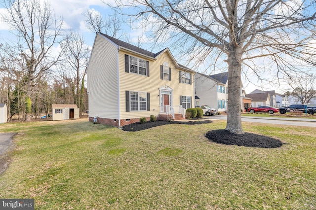 view of front of home with crawl space, an outdoor structure, a front lawn, and a shed