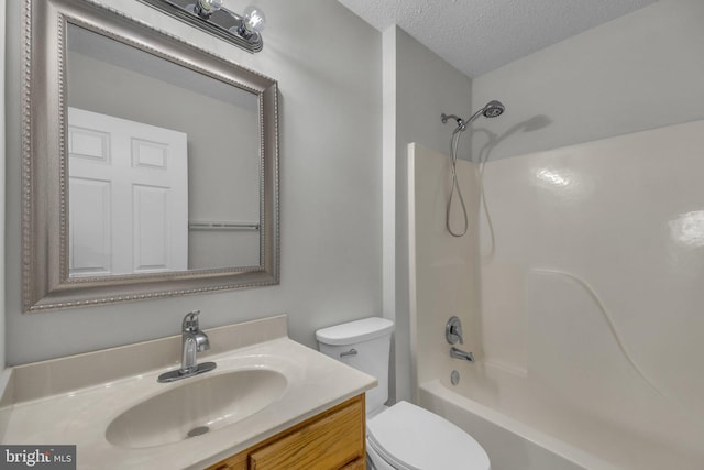 full bath with shower / tub combination, toilet, a textured ceiling, and vanity