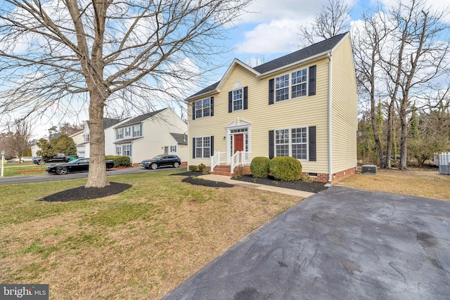 view of front of home with crawl space, central AC unit, and a front lawn