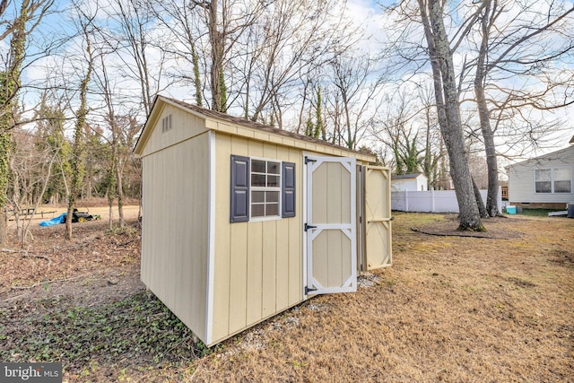 view of shed with fence