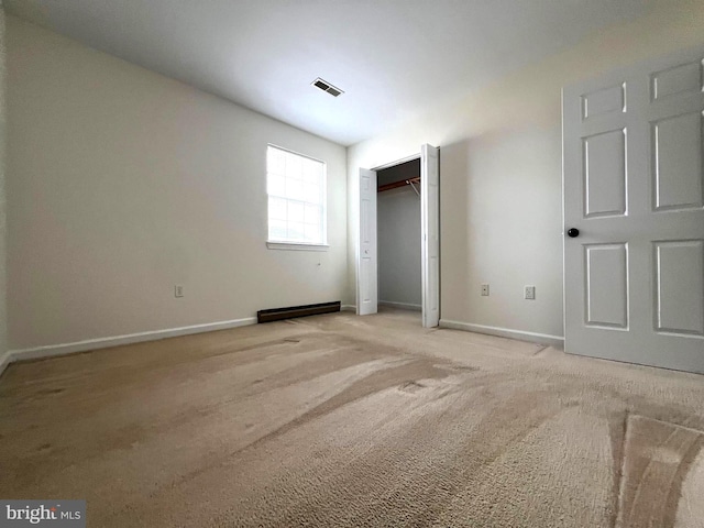 unfurnished bedroom featuring light carpet, visible vents, a closet, and baseboards