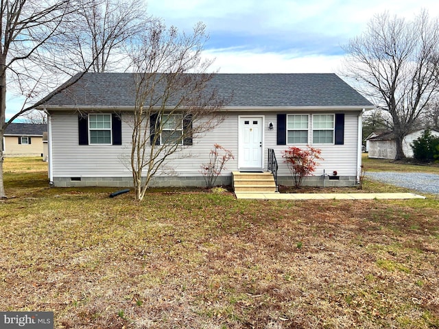 view of front facade featuring a front yard, roof with shingles, and crawl space