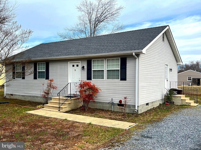 view of front of property with crawl space and a shingled roof