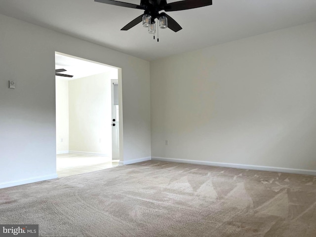 unfurnished room featuring baseboards, carpet floors, and ceiling fan