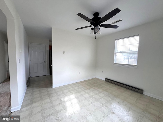 unfurnished room with visible vents, baseboards, baseboard heating, and light floors