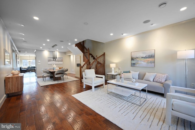 living room with hardwood / wood-style flooring, stairway, recessed lighting, and ornamental molding