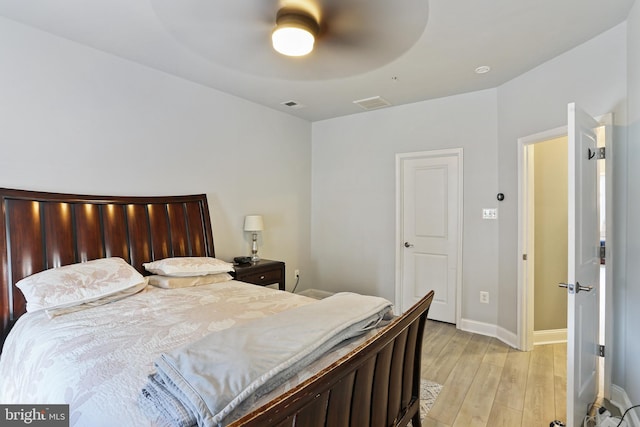 bedroom featuring visible vents, baseboards, light wood-style floors, and ceiling fan