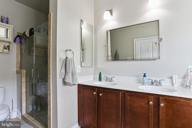 full bath with a shower stall, toilet, and a sink