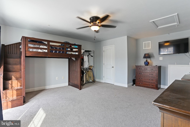 bedroom with baseboards, visible vents, carpet floors, attic access, and ceiling fan