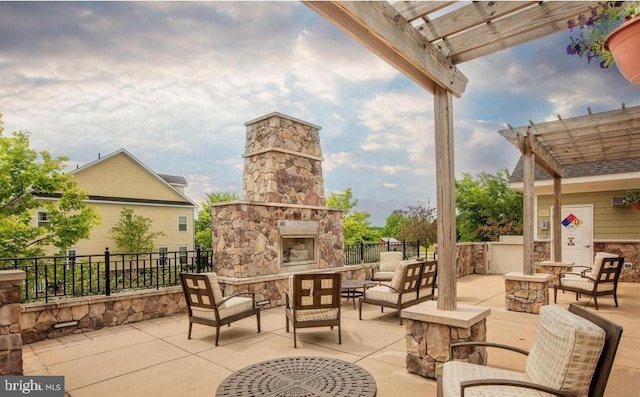 view of patio / terrace featuring fence, a pergola, and an outdoor living space with a fireplace