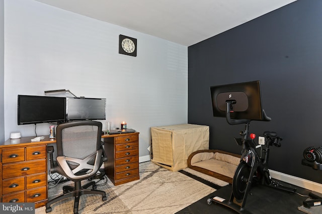 carpeted office space featuring baseboards