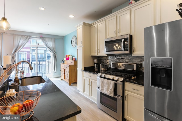 kitchen with tasteful backsplash, light wood finished floors, recessed lighting, appliances with stainless steel finishes, and a sink